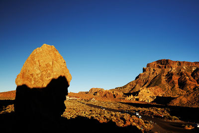 Rock formations at el teide national park against clear blue sky