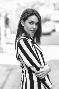 Portrait of young woman standing outdoors