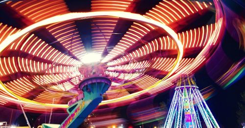 Low angle view of illuminated ferris wheel at night