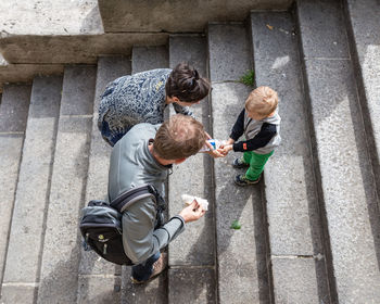 High angle view of father and son playing on steps