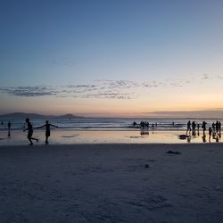 Scenic view of beach against sky during sunset
