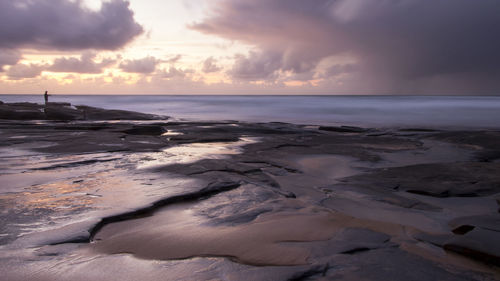 Scenic view of beach against sky during sunset