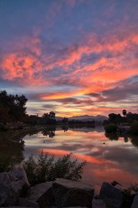 Scenic view of lake against orange sky