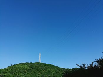 Low angle view of vapor trail against clear blue sky