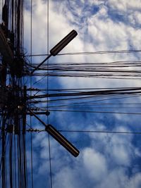 Low angle view of electricity pylon against sky