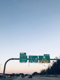 Road sign against sky