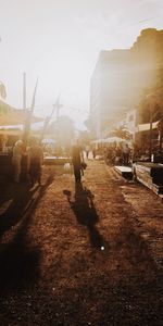 People on street in city against sky