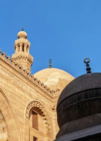 Low angle view of historical building against clear blue sky