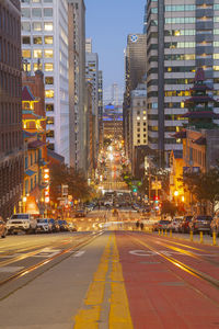 Illuminated city street at night