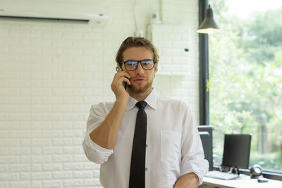 Businessman using smart phone in office