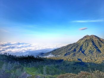 Scenic view of mountain range against blue sky