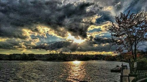 Scenic view of river against cloudy sky