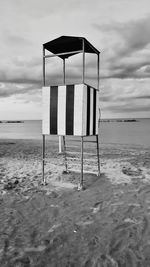 Lifeguard hut on beach against sky