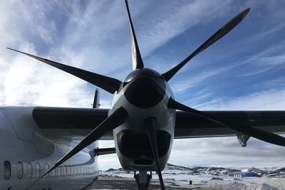 Airplane on runway against sky