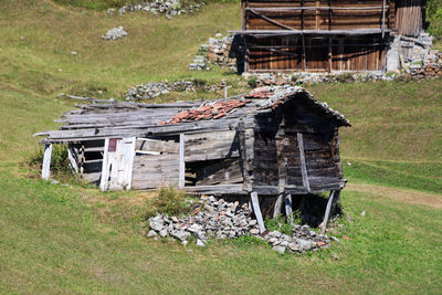 Old abandoned house on field