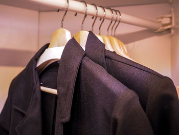 Close-up of blazers hanging in cabinet
