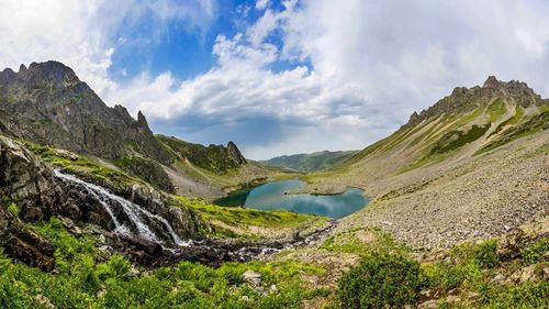 Scenic view of mountains against cloudy sky