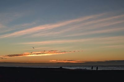 Scenic view of beach against sky during sunset