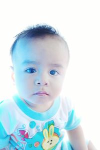 Portrait of cute baby boy against white background
