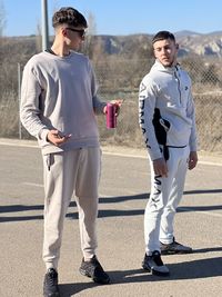 Low angle view of couple standing on road