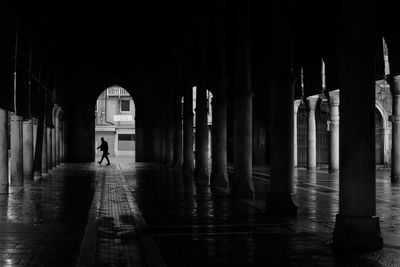 Silhouette man walking in corridor of building