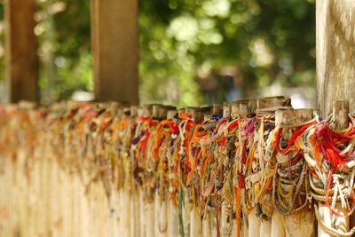 Close-up of bracelets hanging outside temple