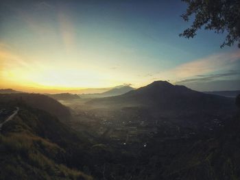 Scenic view of mountains against sky at sunset