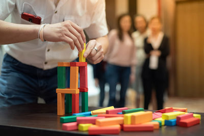 People playing with toy on table