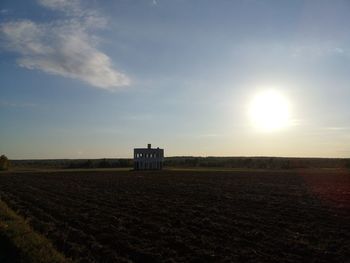 Scenic view of agricultural field against sky during sunset