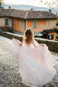 Rear view of bride with bouquet