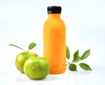 Close-up of fresh green fruits against white background