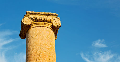 Low angle view of historical building against blue sky