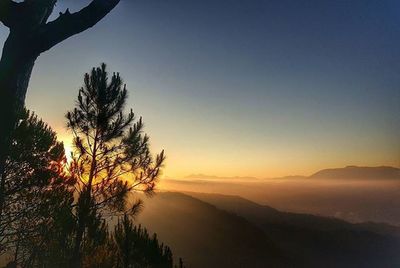 Scenic view of landscape against sky at sunset