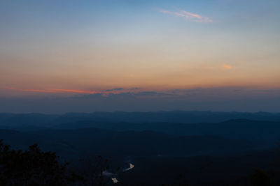 Scenic view of silhouette mountains against sky during sunset