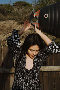 Portrait of a beautiful woman standing against wall