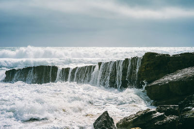 Scenic view of powerful sea against sky