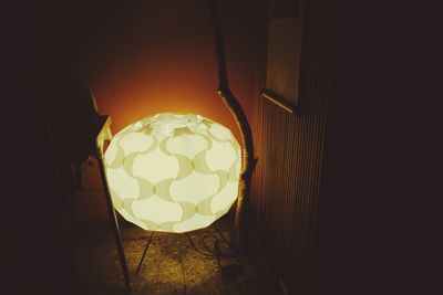 Close-up of illuminated light bulb at home