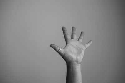 Close-up of human hand against gray background