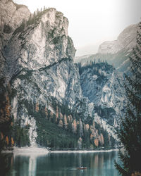 Scenic view of lake by mountains against sky