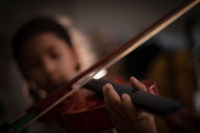 Close-up of woman playing the guitar