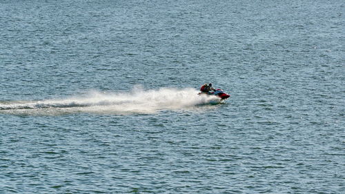 People riding jet boat in sea