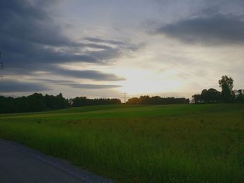 Scenic view of field against sky during sunset