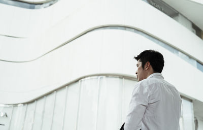 Low angle view of businessman standing in city