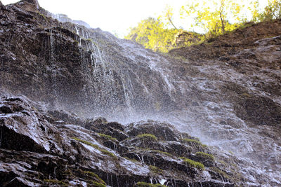 Close-up of waterfall against sky