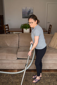 Woman cleaning living room