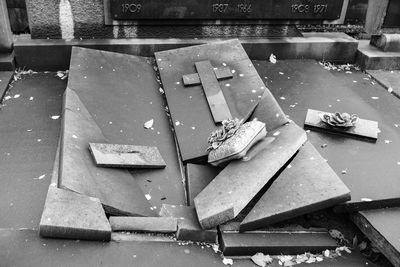 High angle view of broken sign on wet table