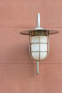 Low angle view of lamp mounted on wall