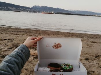 Woman hand on sand at beach