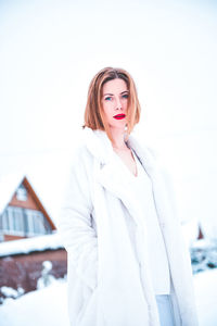 Portrait of beautiful woman standing outdoors during winter