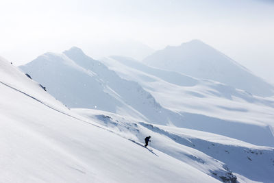 People skiing on snowcapped mountain